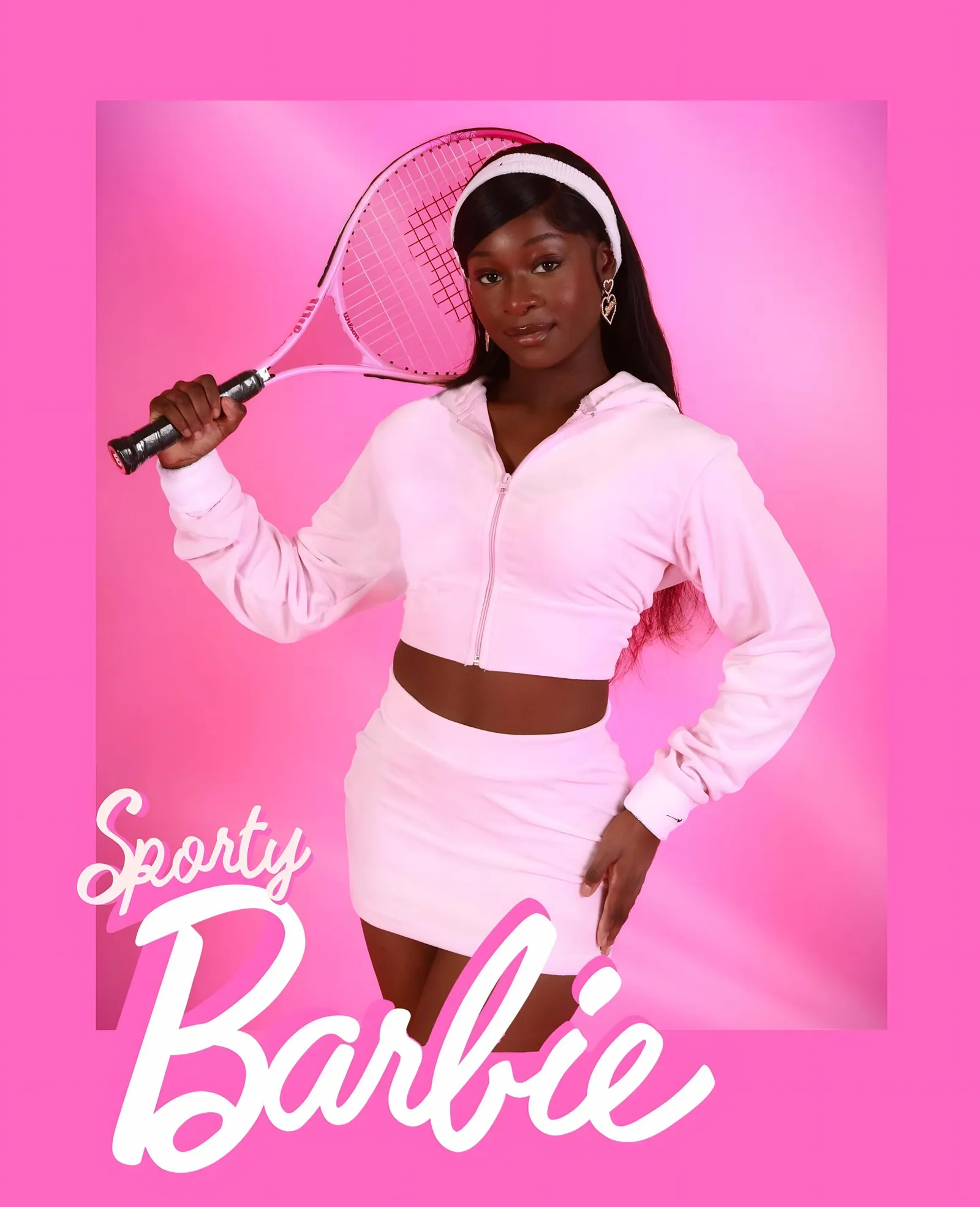 Model in a pink velour zip jacket and skirt with a white headband holding a pink tennis racket, with the text Sporty Barbie